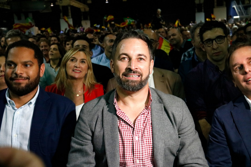 Pla mitjà del president de Vox, Santiago Abascal, assegut al costat del cap de llista a Catalunya, Ignacio Garriga, a l'acte d'inici de campanya